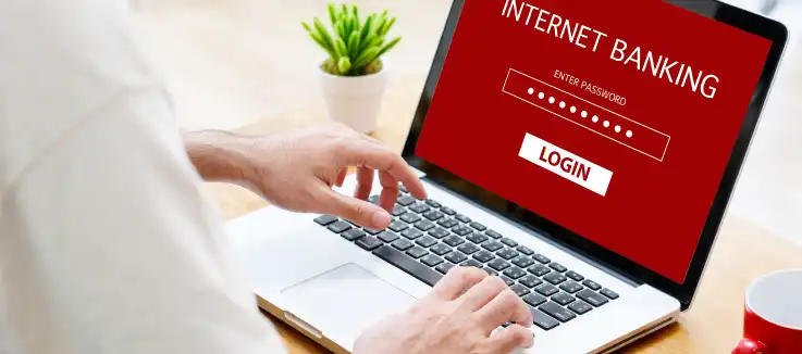 man on laptop logging into his online banking account