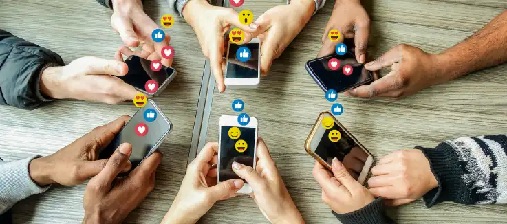 mobile phone users on their phones with social media emojis emerging