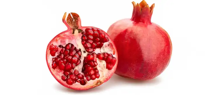 beautiful red pomegranate cut open with a white background 